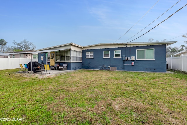 back of house with a yard and a patio area