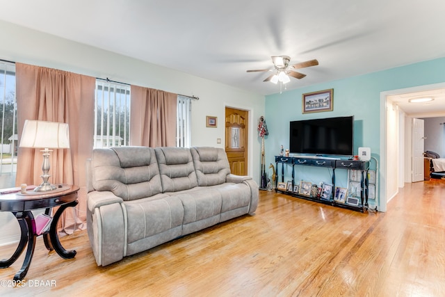 living room with wood-type flooring and ceiling fan