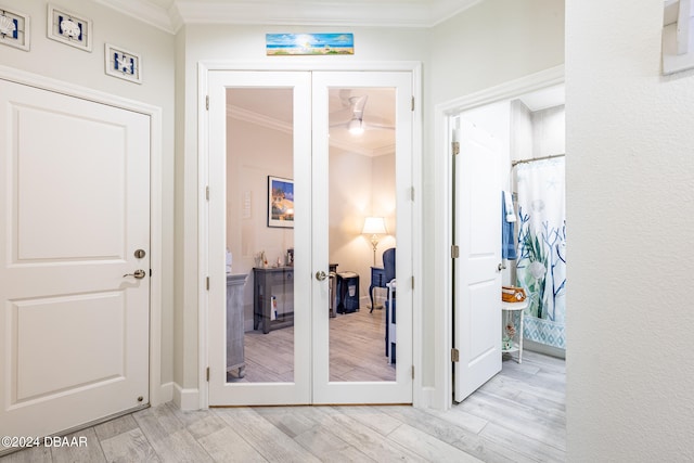 doorway with crown molding, light hardwood / wood-style flooring, and french doors