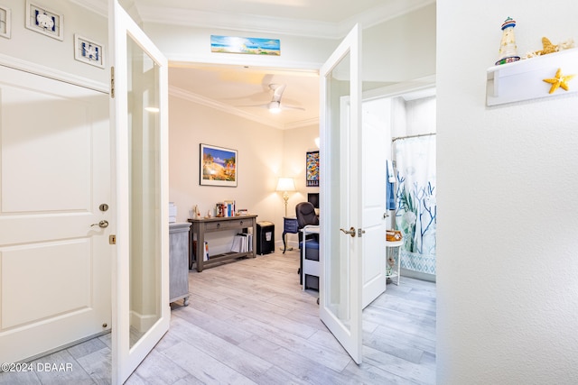 hall featuring light wood-type flooring and ornamental molding