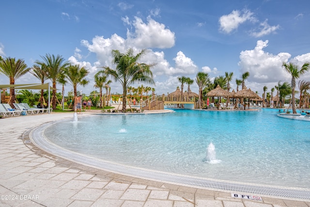 view of swimming pool with pool water feature