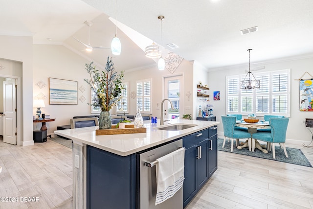 kitchen featuring stainless steel dishwasher, sink, blue cabinetry, and a kitchen island with sink