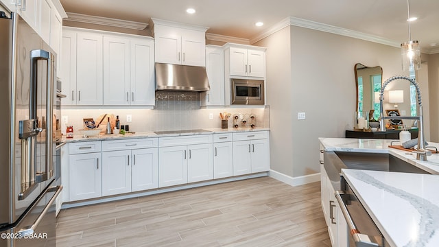 kitchen with white cabinetry, light stone counters, tasteful backsplash, appliances with stainless steel finishes, and crown molding