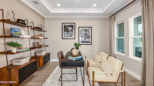 home office featuring light wood-type flooring, plenty of natural light, and crown molding