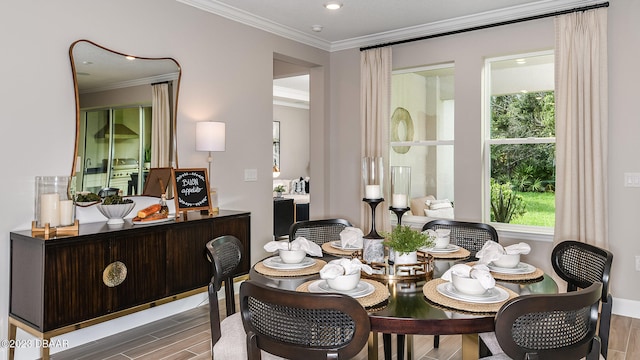 dining space with ornamental molding and wood-type flooring