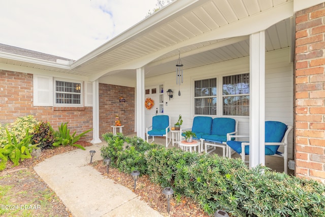 view of exterior entry with a porch