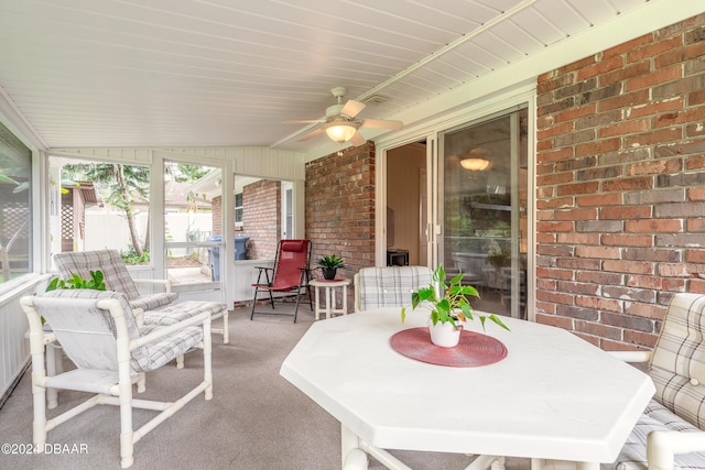 sunroom / solarium with ceiling fan and lofted ceiling