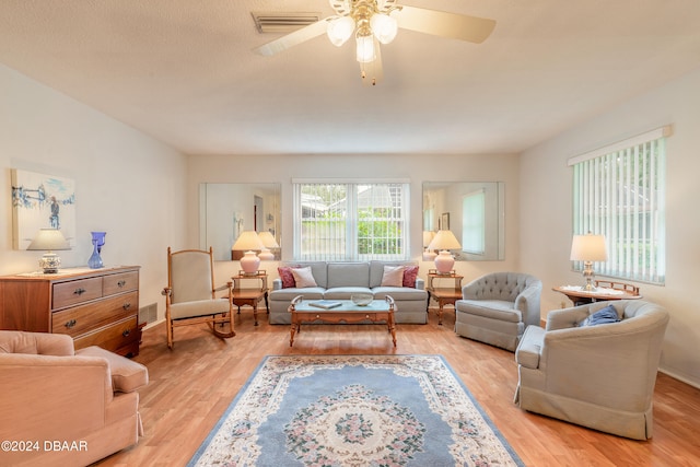 living room featuring ceiling fan and light hardwood / wood-style flooring