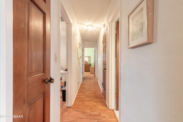 hallway with light hardwood / wood-style flooring