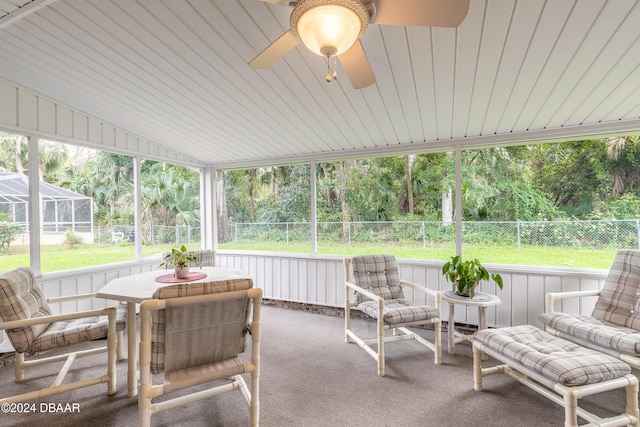 sunroom / solarium featuring ceiling fan and lofted ceiling