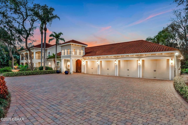 mediterranean / spanish-style house featuring a balcony and a garage