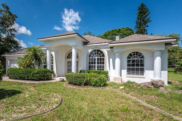 6062 Sabal Crossing Ct, Port Orange, FL 32128 - view of front of home with stucco siding, a front yard, a shingled roof, and a garage