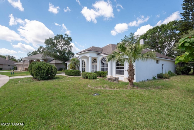 6062 Sabal Crossing Ct, Port Orange, FL 32128 - view of front facade featuring a front yard and stucco siding
