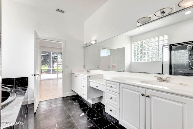 6062 Sabal Crossing Ct, Port Orange, FL 32128 - full bathroom featuring double vanity, baseboards, and a relaxing tiled tub