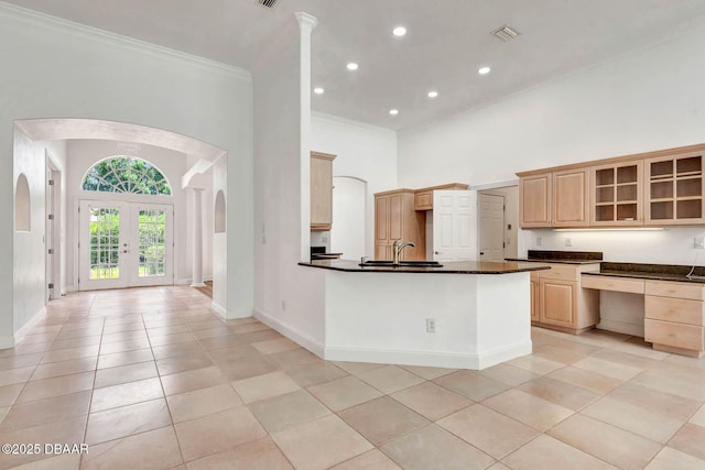 6062 Sabal Crossing Ct, Port Orange, FL 32128 - kitchen with arched walkways, ornamental molding, dark countertops, a sink, and baseboards