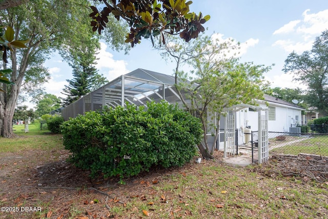 6062 Sabal Crossing Ct, Port Orange, FL 32128 - view of yard featuring fence, central air condition unit, a lanai, and a storage unit