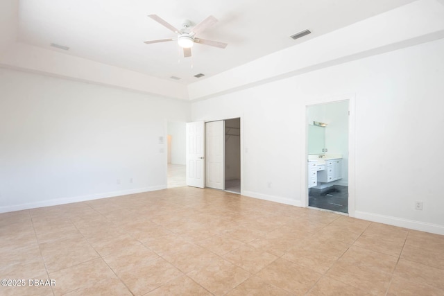 6062 Sabal Crossing Ct, Port Orange, FL 32128 - unfurnished bedroom featuring a closet, connected bathroom, baseboards, a ceiling fan, and a high ceiling
