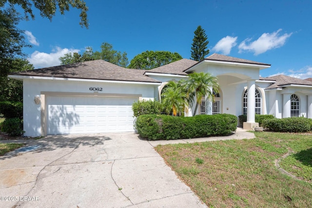 6062 Sabal Crossing Ct, Port Orange, FL 32128 - view of front facade featuring an attached garage, driveway, and stucco siding