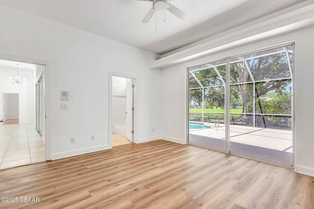 6062 Sabal Crossing Ct, Port Orange, FL 32128 - unfurnished room featuring a chandelier, healthy amount of natural light, and light wood-style floors