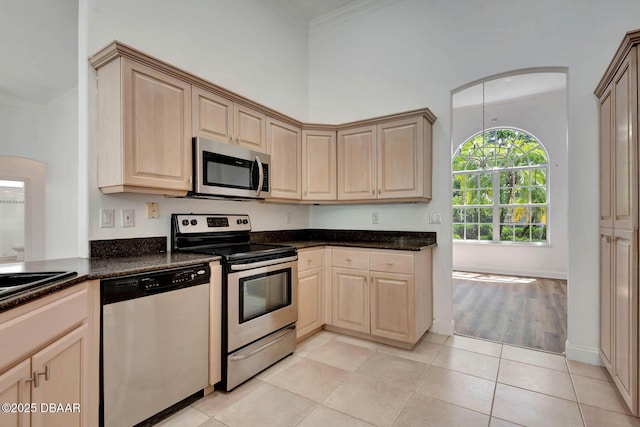 6062 Sabal Crossing Ct, Port Orange, FL 32128 - kitchen featuring appliances with stainless steel finishes, ornamental molding, light brown cabinets, light tile patterned flooring, and arched walkways