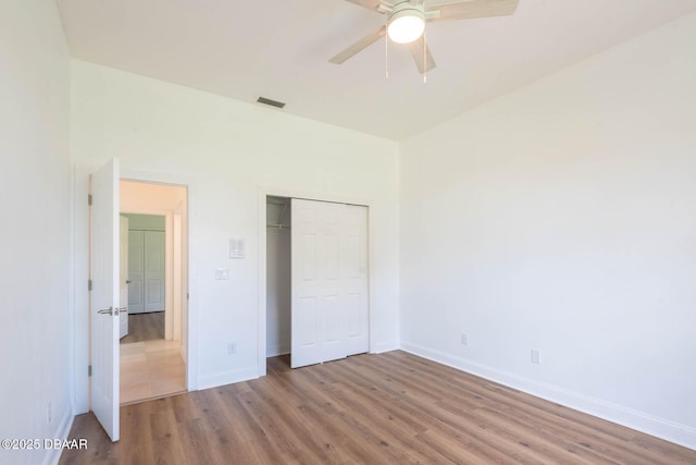6062 Sabal Crossing Ct, Port Orange, FL 32128 - unfurnished bedroom with wood finished floors, a closet, baseboards, and a ceiling fan
