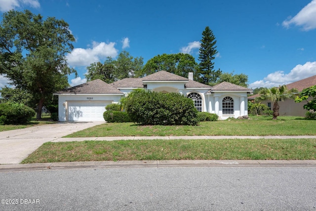 6062 Sabal Crossing Ct, Port Orange, FL 32128 - mediterranean / spanish-style home featuring stucco siding, an attached garage, a front yard, and concrete driveway