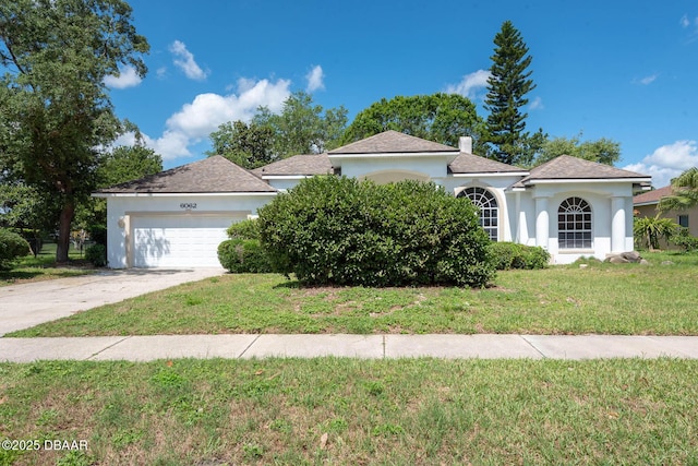 6062 Sabal Crossing Ct, Port Orange, FL 32128 - view of front of house with an attached garage, stucco siding, a front yard, driveway, and a chimney