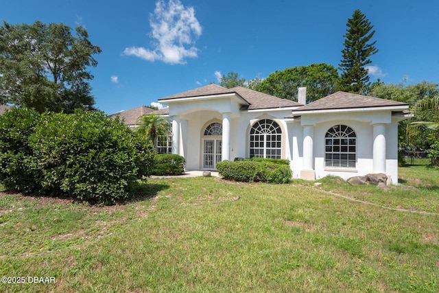 6062 Sabal Crossing Ct, Port Orange, FL 32128 - mediterranean / spanish home with a front lawn, stucco siding, and a shingled roof