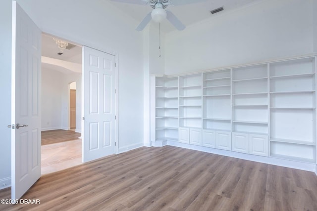 6062 Sabal Crossing Ct, Port Orange, FL 32128 - empty room featuring arched walkways, ceiling fan, wood finished floors, and baseboards