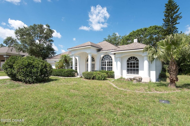 6062 Sabal Crossing Ct, Port Orange, FL 32128 - mediterranean / spanish home featuring a front yard, stucco siding, and a chimney