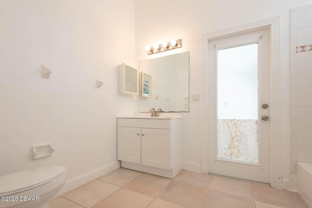 6062 Sabal Crossing Ct, Port Orange, FL 32128 - full bathroom with tile patterned floors, toilet, a bathtub, vanity, and baseboards