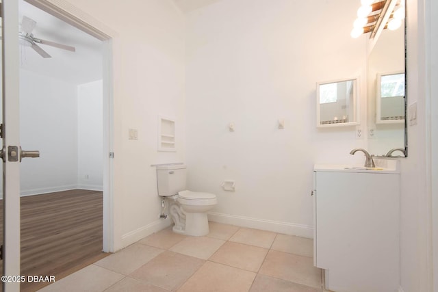 6062 Sabal Crossing Ct, Port Orange, FL 32128 - bathroom featuring baseboards, toilet, a ceiling fan, tile patterned floors, and vanity