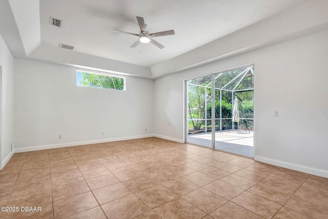6062 Sabal Crossing Ct, Port Orange, FL 32128 - spare room with light tile patterned floors, ceiling fan, baseboards, and a raised ceiling