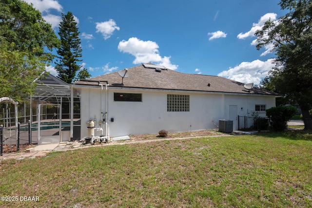 6062 Sabal Crossing Ct, Port Orange, FL 32128 - back of property featuring stucco siding, central AC unit, an outdoor pool, glass enclosure, and roof with shingles
