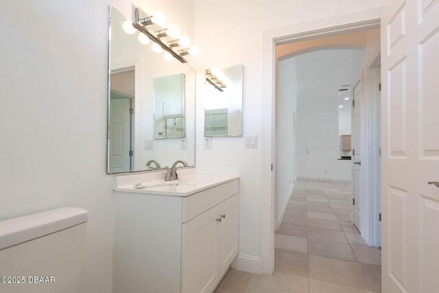 6062 Sabal Crossing Ct, Port Orange, FL 32128 - bathroom featuring toilet, tile patterned flooring, vanity, and baseboards