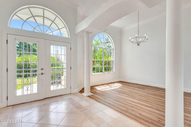 6062 Sabal Crossing Ct, Port Orange, FL 32128 - entrance foyer with decorative columns, a chandelier, and baseboards