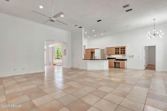 6062 Sabal Crossing Ct, Port Orange, FL 32128 - unfurnished living room featuring arched walkways, a high ceiling, light tile patterned floors, a chandelier, and a ceiling fan