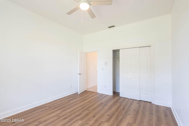 6062 Sabal Crossing Ct, Port Orange, FL 32128 - unfurnished bedroom with wood finished floors, a closet, baseboards, and ceiling fan