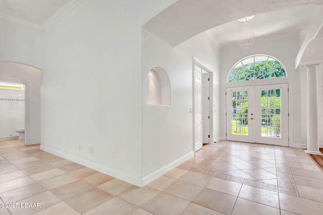 6062 Sabal Crossing Ct, Port Orange, FL 32128 - foyer with a towering ceiling, light tile patterned floors, french doors, baseboards, and ornamental molding