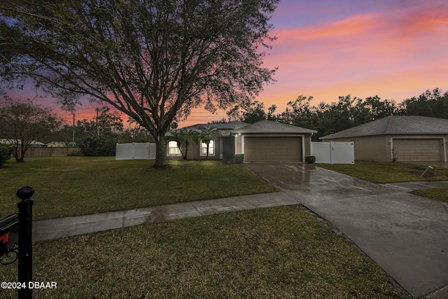 view of front facade featuring a garage and a lawn