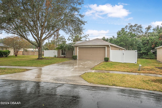 view of front of property with a garage and a front yard