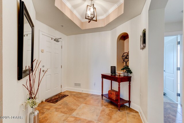 146 Palm Coast Resort Blvd Unit 501, Palm Coast, FL 32137 - entrance foyer with a chandelier, crown molding, and a tray ceiling