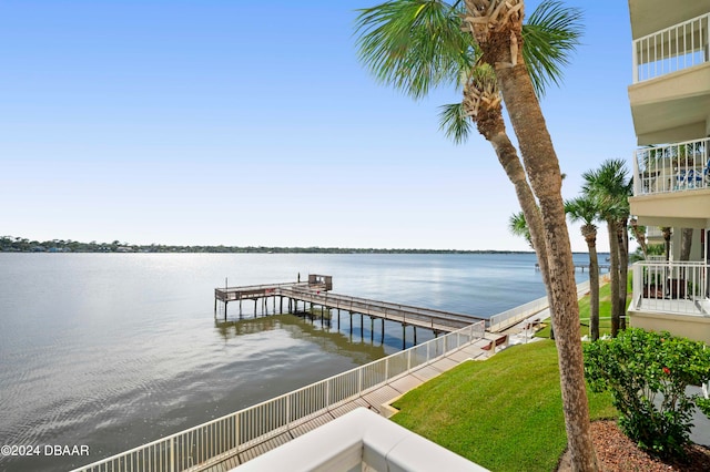 view of dock featuring a water view and a balcony