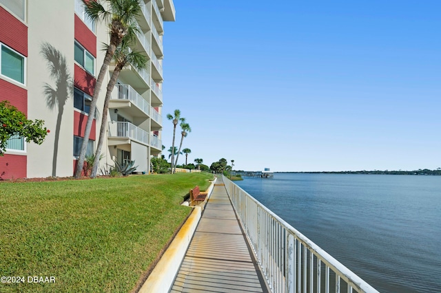 view of home's community featuring a water view and a yard