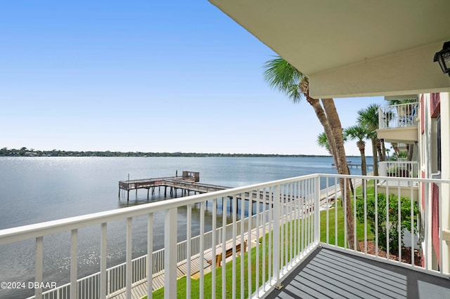 balcony featuring a water view and a boat dock