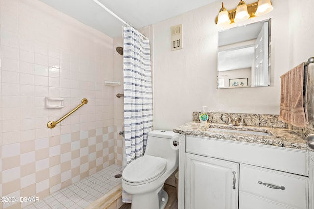 bathroom with vanity, curtained shower, and toilet