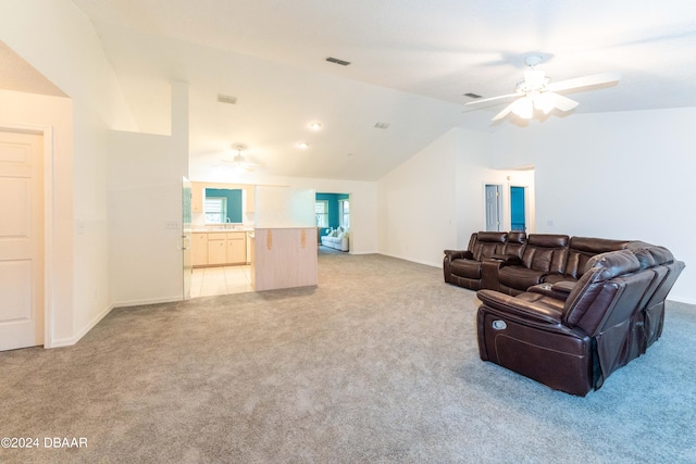 living room with light carpet, ceiling fan, and vaulted ceiling