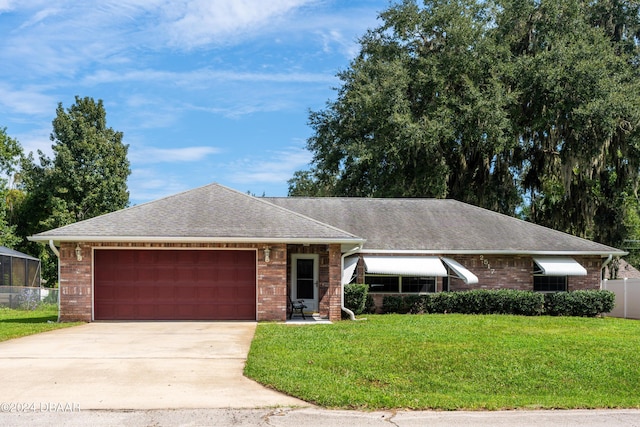 ranch-style home featuring a garage and a front lawn