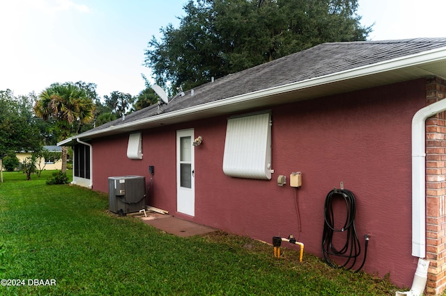 view of property exterior featuring a yard and central AC unit