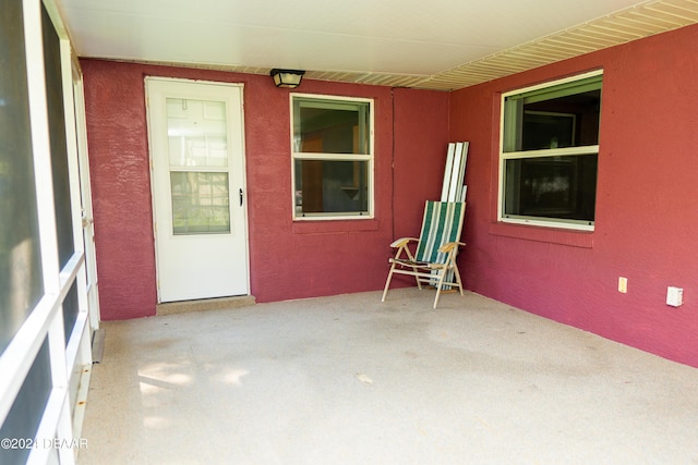 unfurnished bedroom featuring light carpet, ceiling fan, a spacious closet, a textured ceiling, and connected bathroom